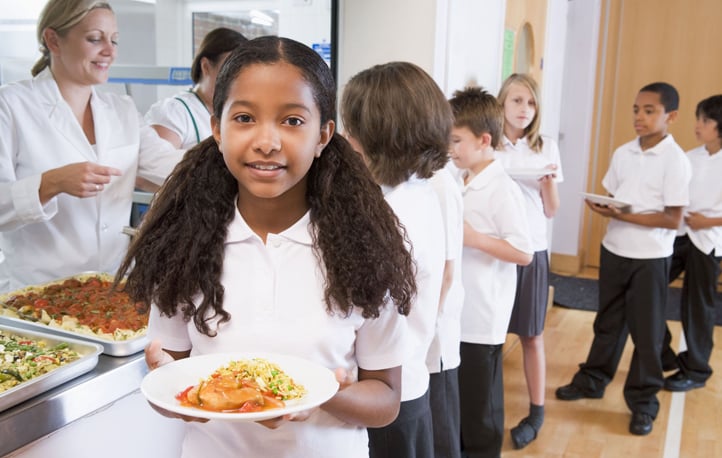 Students standing in a lunch line.